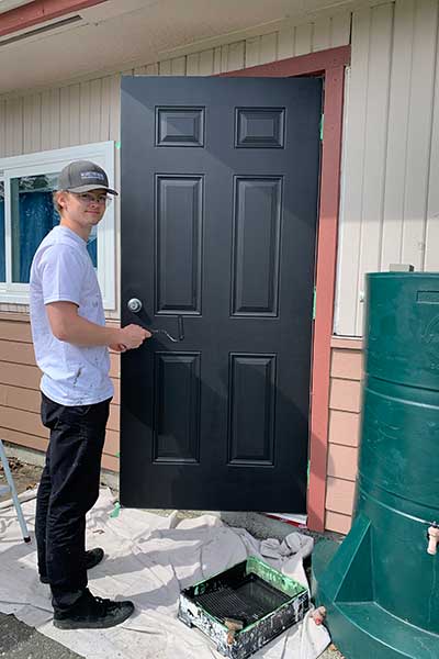 Ben painting a door
